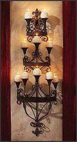 Everything is more beautiful in candlelight! Ready to light any evening, this classically elegant symphony of light and scrollwork is an absolutely unparalleled romantic candlelight accent. You'll welcome the instant ambiance of candlelight with our wall-mounted, hand-crafted, matte black metal work of decorative art. Whether in the boudoir, bath, dining or formal living room, the flicker of your favorite candles makes this Design Toscano exclusive statement piece complete. A great wedding, anniversary or housewarming gift!